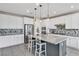 Modern kitchen boasts granite countertops, stainless steel appliances, backsplash, and center island with seating at 9675 Bold Skye Ave, Las Vegas, NV 89166