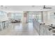 Open-concept living space with tile floors, modern lighting, and backyard access at 9675 Bold Skye Ave, Las Vegas, NV 89166