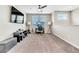 Open living room with neutral walls, carpet flooring, with desk and entertainment center at 9675 Bold Skye Ave, Las Vegas, NV 89166