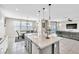 Open concept kitchen, dining and living room area with lots of natural light at 9675 Bold Skye Ave, Las Vegas, NV 89166