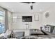 Bright living room featuring a ceiling fan, tile flooring, and backyard access at 9675 Bold Skye Ave, Las Vegas, NV 89166