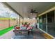 Covered outdoor patio with comfortable seating and ceiling fans at 9675 Bold Skye Ave, Las Vegas, NV 89166