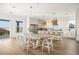 Open-concept kitchen and dining area with modern appliances and a large center island with bar seating at 10420 Luella Ct, Las Vegas, NV 89143