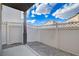 Enclosed back patio area with stone landscaping and privacy fence at 10429 Amber Night St, Las Vegas, NV 89183