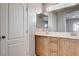 Well-lit bathroom featuring a dual sink vanity with wooden cabinets at 10429 Amber Night St, Las Vegas, NV 89183