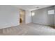 Spacious bedroom with neutral paint, carpet and convenient access to a bathroom at 10429 Amber Night St, Las Vegas, NV 89183