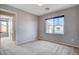 This bedroom features a window and a door leading to another room at 10429 Amber Night St, Las Vegas, NV 89183