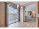 Dining area featuring tile flooring, a chandelier, and sliding door access to the backyard at 10429 Amber Night St, Las Vegas, NV 89183