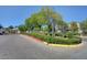 Community entrance sign with lush landscaping and secure gate at 10429 Amber Night St, Las Vegas, NV 89183