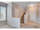 Bright foyer with staircase, large window, and tile/carpet flooring at 10429 Amber Night St, Las Vegas, NV 89183