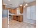 Bright kitchen with wood cabinets, stainless appliances, and tile floors at 10429 Amber Night St, Las Vegas, NV 89183