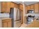 Kitchen with wood cabinets and stainless steel refrigerator and oven at 10429 Amber Night St, Las Vegas, NV 89183
