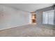 Spacious living room featuring neutral paint and flooring with view to the kitchen at 10429 Amber Night St, Las Vegas, NV 89183