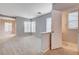 Spacious living room adjacent to half bathroom and lots of windows at 10429 Amber Night St, Las Vegas, NV 89183