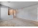 Spacious living room featuring neutral paint and flooring with view to the stairwell at 10429 Amber Night St, Las Vegas, NV 89183