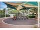 Community playground featuring slides and climbing structures under a shaded canopy at 10429 Amber Night St, Las Vegas, NV 89183