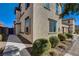 Exterior view features stucco walls, manicured bushes, a concrete walkway, and brick pavers leading to a private gate at 1055 Admiral Emblem St, Henderson, NV 89015