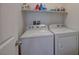 Compact laundry room features a washer, a dryer, and storage at 1055 Admiral Emblem St, Henderson, NV 89015