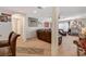 Cozy living room with leather furniture, neutral carpet, a ceiling fan, and tasteful decorations creating a welcoming atmosphere at 1055 Admiral Emblem St, Henderson, NV 89015