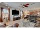 The spacious living room features modern lighting, media center, a ceiling fan, and lots of natural light at 1055 Admiral Emblem St, Henderson, NV 89015