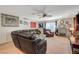 Spacious living room with a large sectional sofa, ceiling fan, and lots of natural light at 1055 Admiral Emblem St, Henderson, NV 89015
