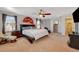 The spacious main bedroom has carpet floors, a fan, and sitting area at 1055 Admiral Emblem St, Henderson, NV 89015
