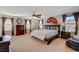 A spacious main bedroom featuring a ceiling fan, carpet floors, and many windows at 1055 Admiral Emblem St, Henderson, NV 89015