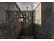 Close up view of stand up shower with granite walls and tile flooring at 1055 Admiral Emblem St, Henderson, NV 89015
