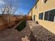 A backyard featuring a paver patio, minimal landscaping, and easy access to the home at 10715 York Manor Ave, Las Vegas, NV 89166