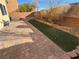 Paver patio and artificial grass in a well-maintained and private backyard setting at 10715 York Manor Ave, Las Vegas, NV 89166