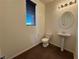 Powder room with pedestal sink, brown tile floor, and blinds at 10715 York Manor Ave, Las Vegas, NV 89166