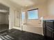 Bathroom showcasing a glass-enclosed shower and a large soaking tub with black tile flooring at 10715 York Manor Ave, Las Vegas, NV 89166