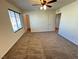 Bedroom with neutral carpeting, a ceiling fan, and a walk-in closet at 10715 York Manor Ave, Las Vegas, NV 89166