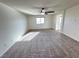 Spacious bedroom featuring neutral carpet, ceiling fan, and ample natural light at 10715 York Manor Ave, Las Vegas, NV 89166