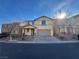 Charming two-story home featuring a well-manicured lawn, a two-car garage and a beautiful blue sky at 10715 York Manor Ave, Las Vegas, NV 89166