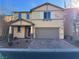 Inviting two-story home with a well-kept front yard, paver driveway, and neutral color palette at 10715 York Manor Ave, Las Vegas, NV 89166