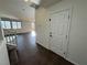 The hallway features tile flooring, a staircase, a white door, and natural light at 10715 York Manor Ave, Las Vegas, NV 89166