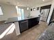 The kitchen features an island with a sink, stainless steel appliances and access to the back yard at 10715 York Manor Ave, Las Vegas, NV 89166