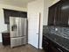 Updated kitchen features stainless steel appliances, granite countertops, and stylish backsplash at 10715 York Manor Ave, Las Vegas, NV 89166