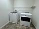 Laundry room featuring tile flooring, washer, dryer and overhead shelving at 10715 York Manor Ave, Las Vegas, NV 89166
