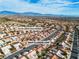 Aerial view shows property next to Eagle Crest Golf Course with mountain views in distance at 10801 Clarion Ln, Las Vegas, NV 89134