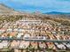 An aerial view shows property near Eagle Crest Golf Course with mountains in the background at 10801 Clarion Ln, Las Vegas, NV 89134