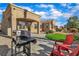 Comfortable backyard, featuring artificial turf, a covered patio, desert landscaping, a built-in barbeque, and comfortable seating at 10801 Clarion Ln, Las Vegas, NV 89134