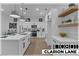 Bright modern kitchen boasts white cabinets, stainless steel appliances, and a functional center island at 10801 Clarion Ln, Las Vegas, NV 89134