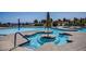 Resort-style pool with sun umbrellas, lounge chairs, water features, and scenic community views at 10801 Clarion Ln, Las Vegas, NV 89134