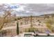Expansive backyard with a pool and spa overlooking a desert landscape and golf course at 11241 Golden Chestnut Pl, Las Vegas, NV 89135