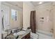 Bathroom featuring a granite counter, tiled shower, and decorative shower curtain at 11241 Golden Chestnut Pl, Las Vegas, NV 89135