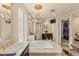 Elegant bathroom featuring a soaking tub, dual sinks, vanity and a walk-in shower at 11241 Golden Chestnut Pl, Las Vegas, NV 89135