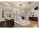 Elegant bathroom featuring a soaking tub, dual sinks, vanity and a walk-in shower at 11241 Golden Chestnut Pl, Las Vegas, NV 89135