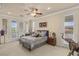 Bedroom with patterned duvet, ceiling fan, balcony access and an elephant statue at 11241 Golden Chestnut Pl, Las Vegas, NV 89135
